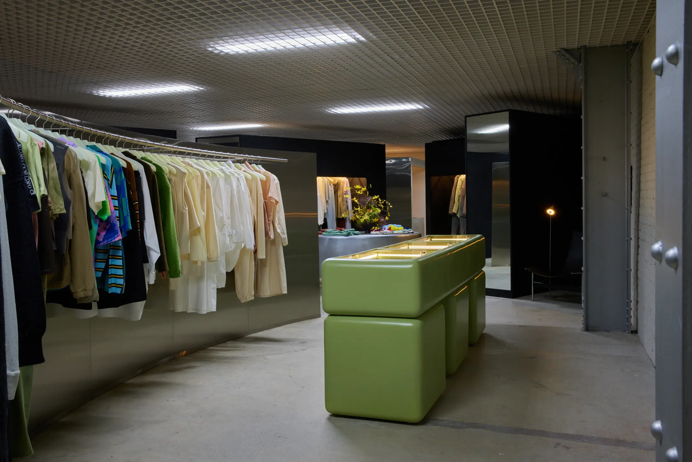 A clothing rail and green counter inside Departamento at Signal