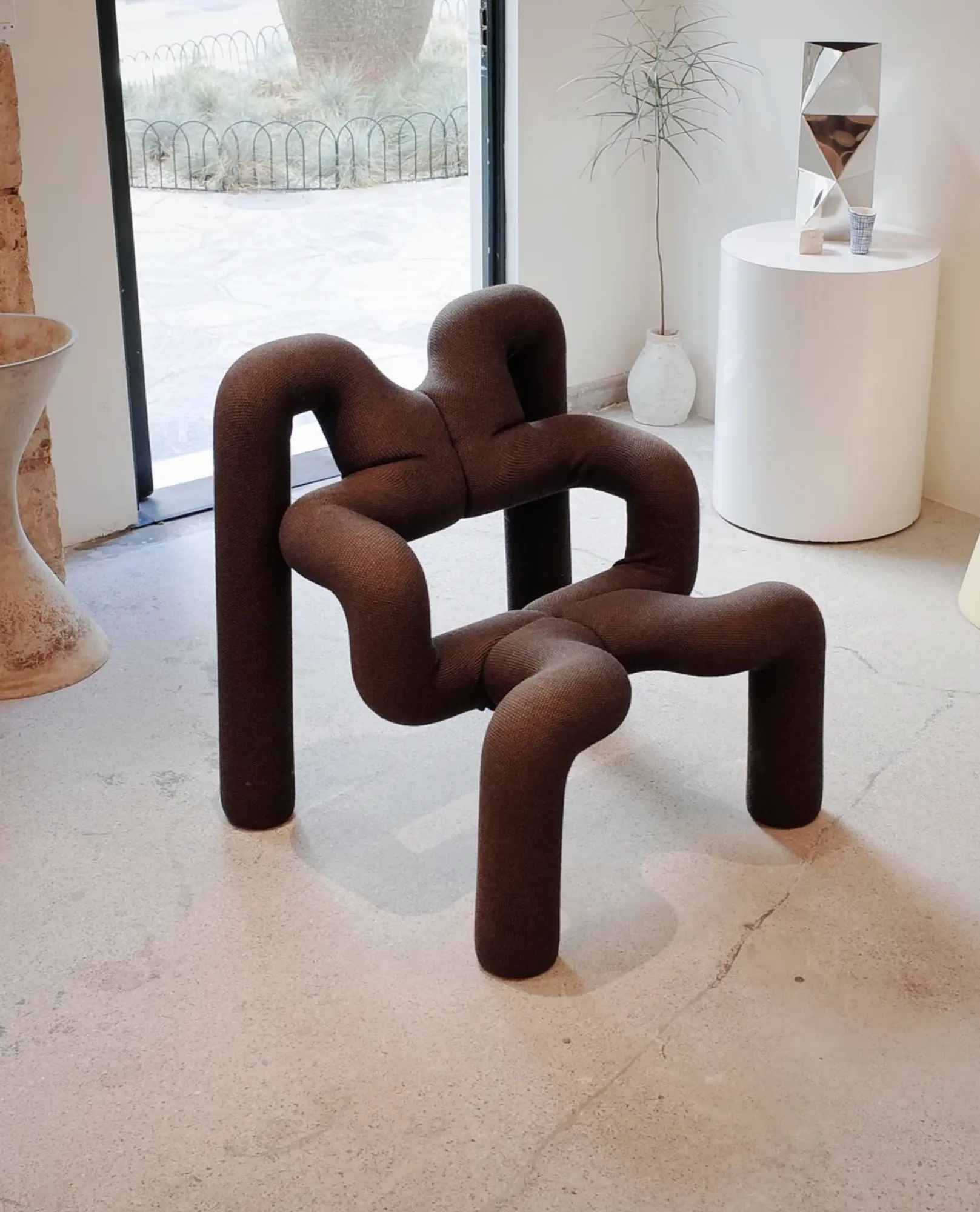 A brown tubular sculptural chair at Formas