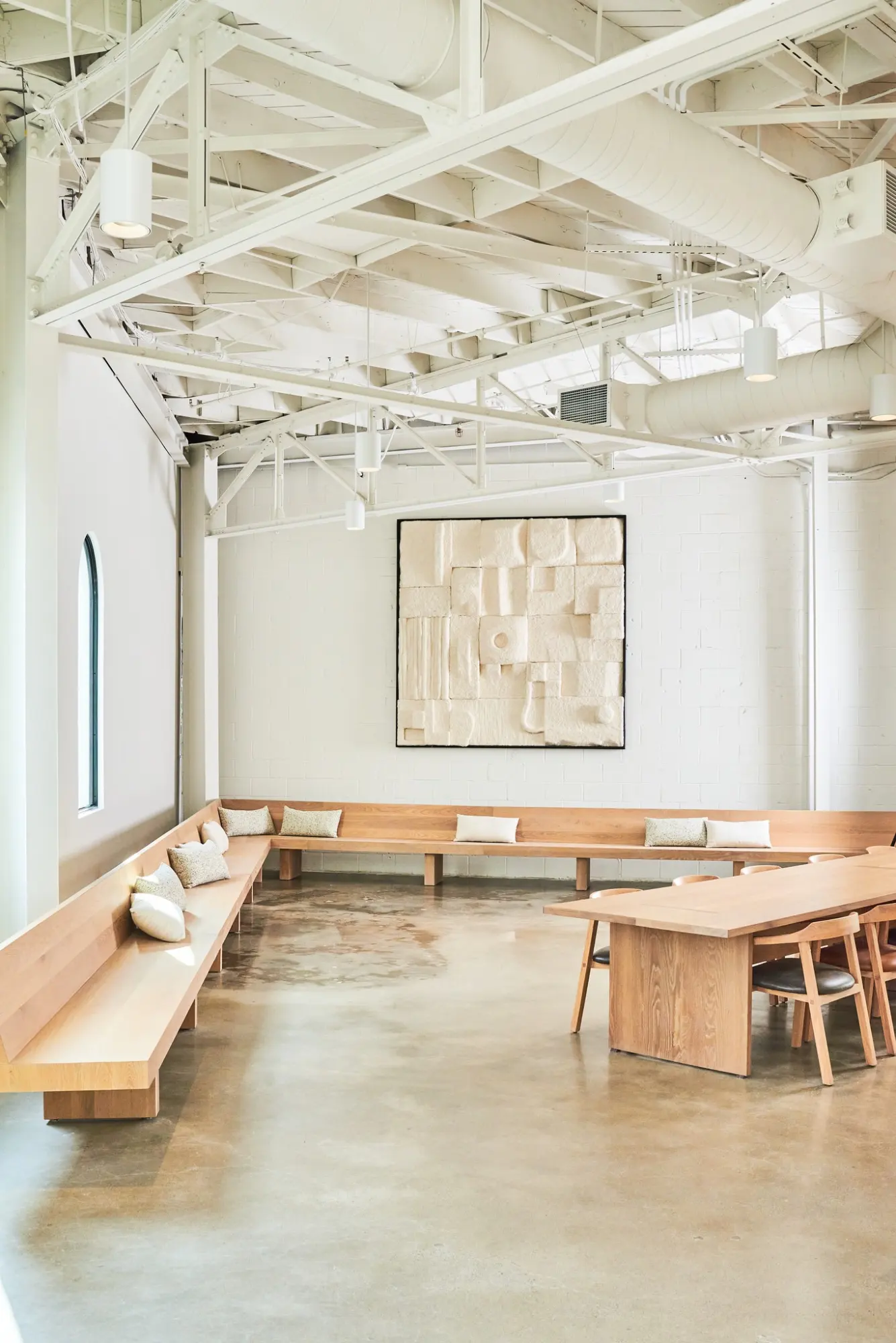 The Greycroft office at Signal with long benches and a wooden table