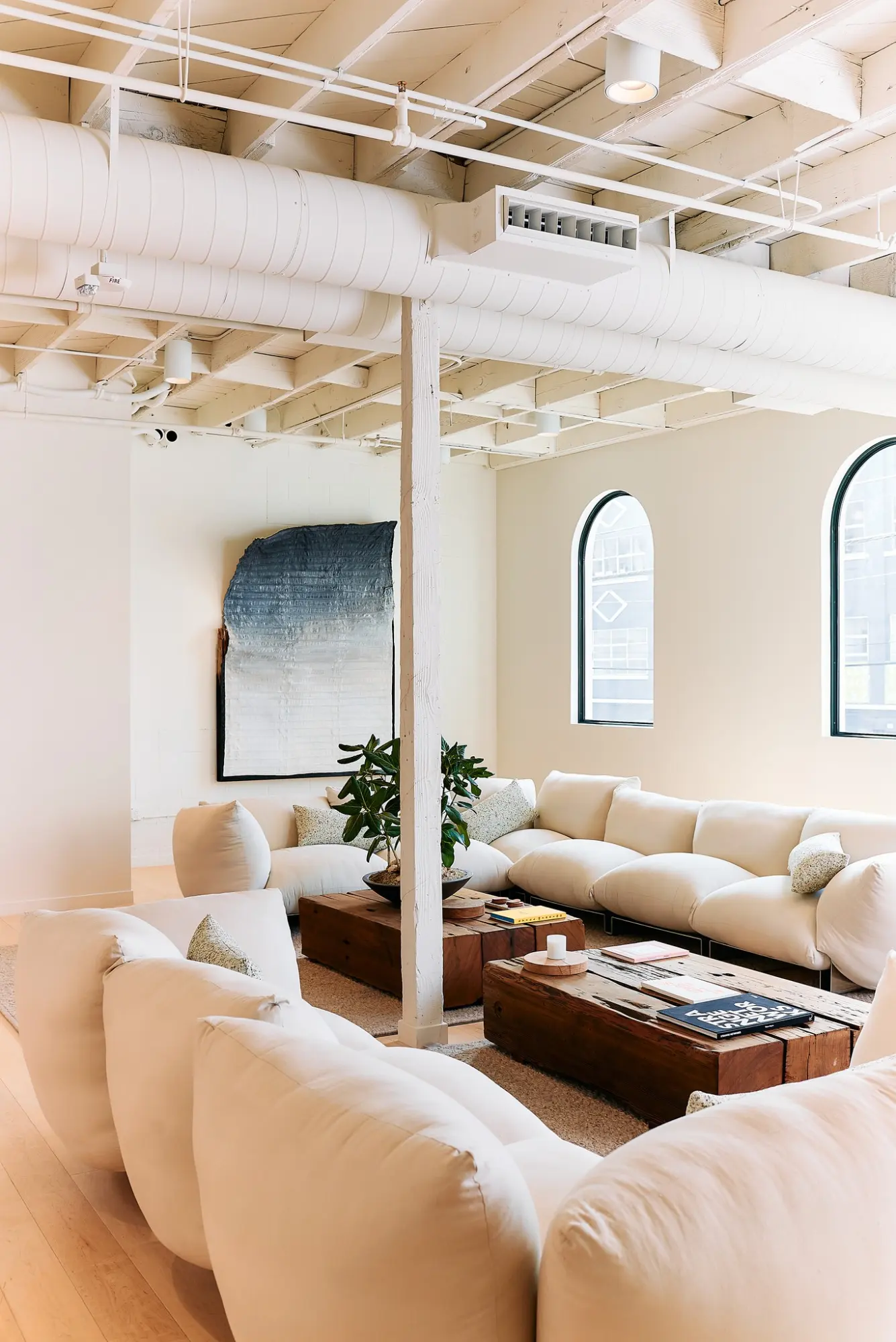 A lounge with cream sofas in the Greycroft office at Signal