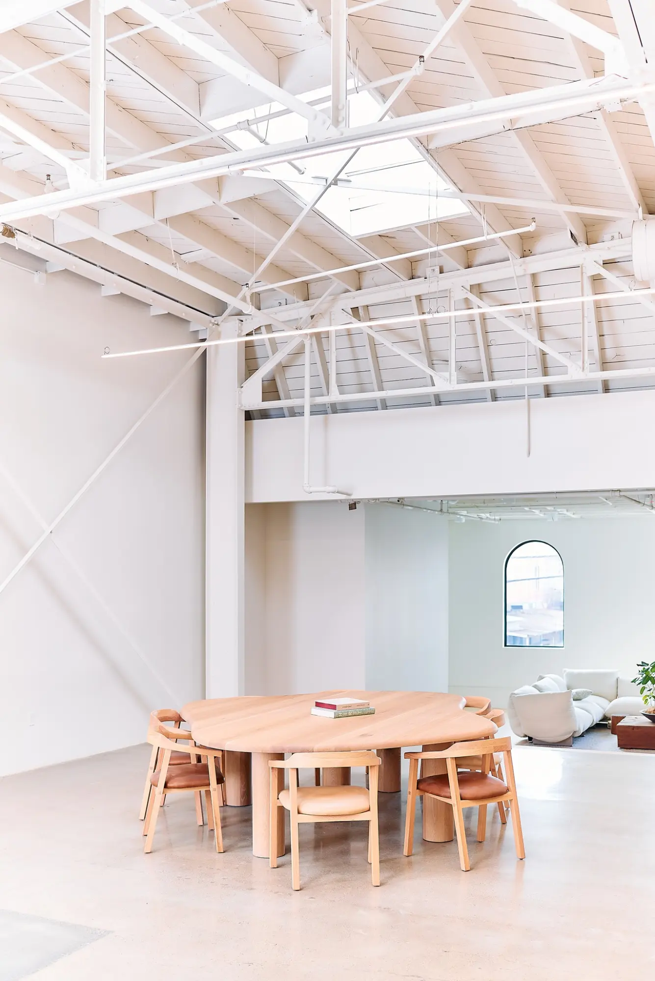 A round wooden table under the skylights in the Greycroft office at Signal