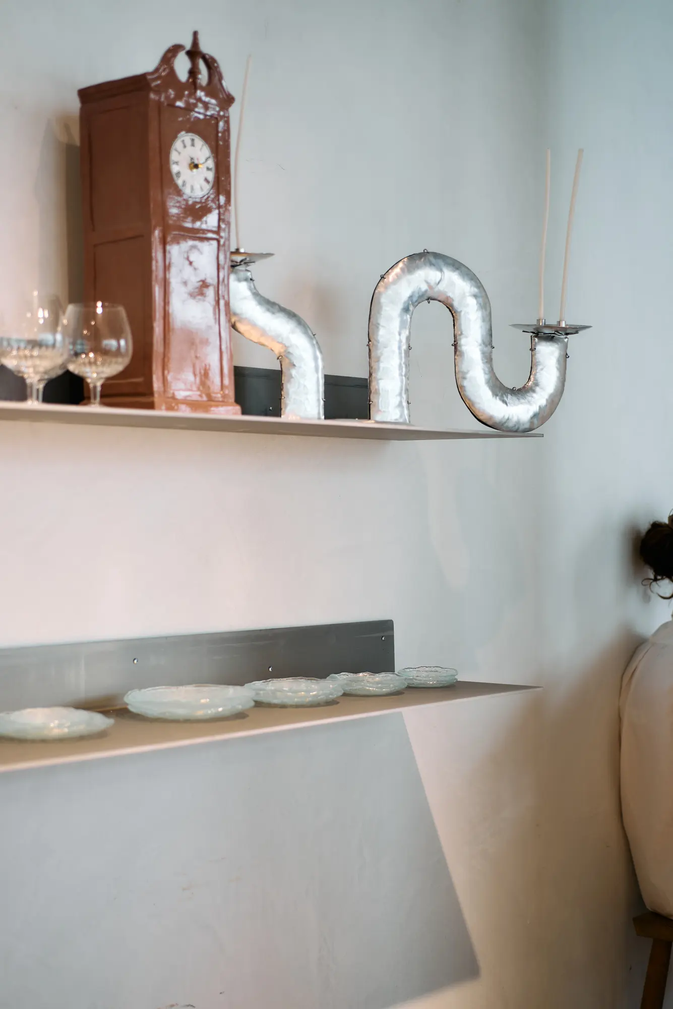 A clock and objects on a shelf at Klein