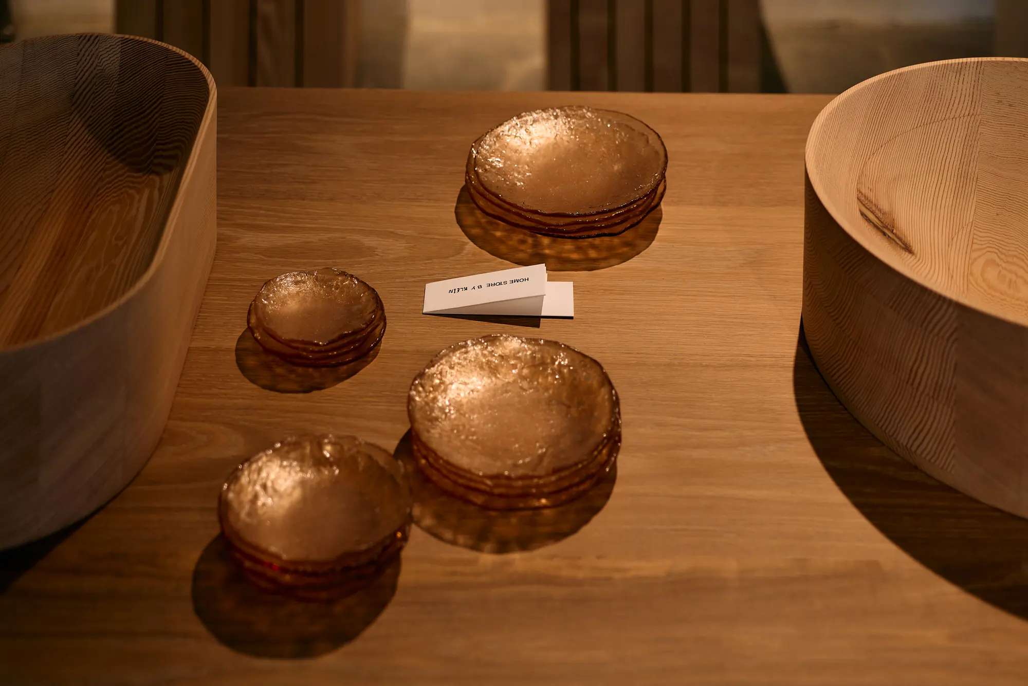 Small copper dishes on a wooden table at Klein