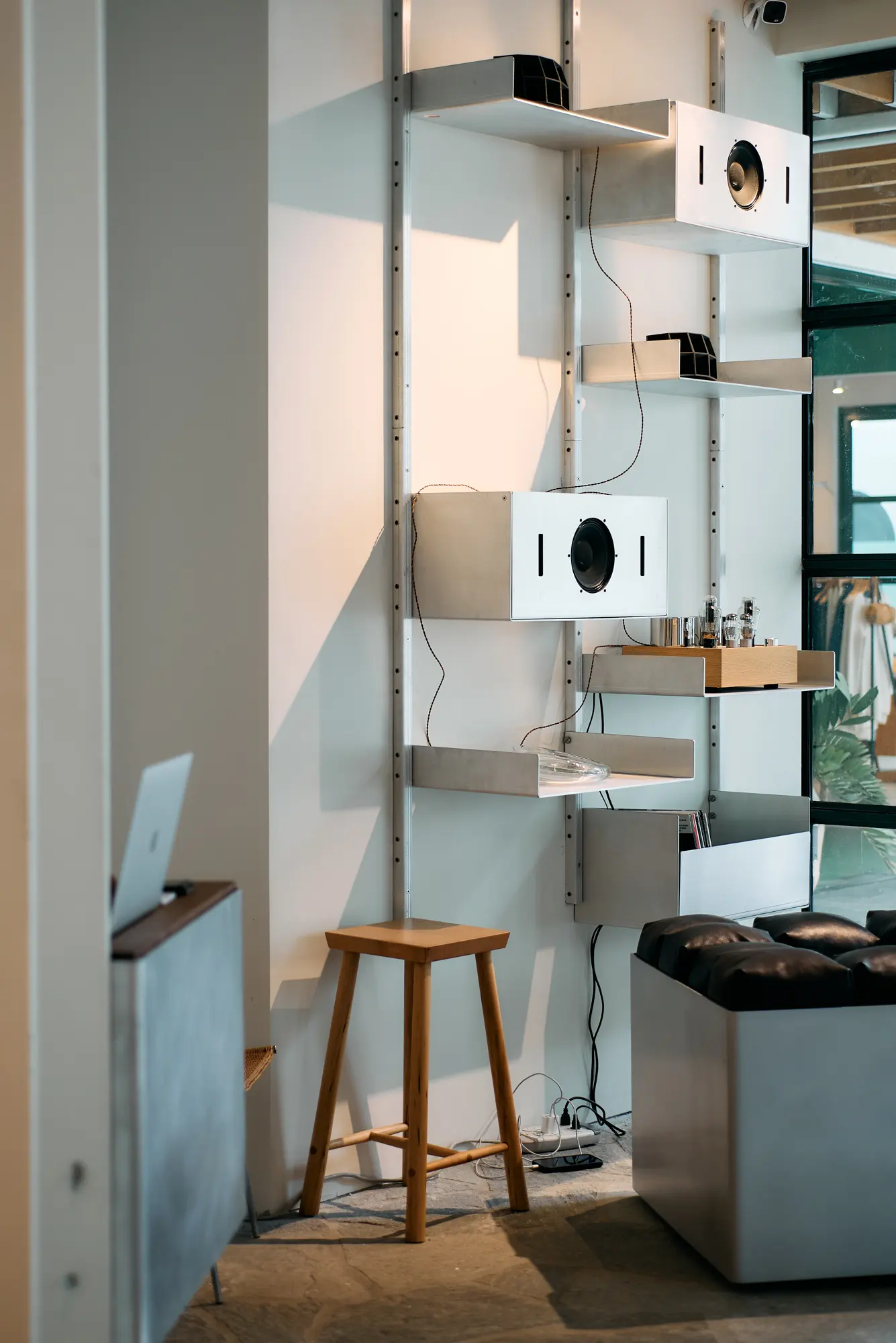 Metal shelving and a wooden stool in the Klein home store at Signal