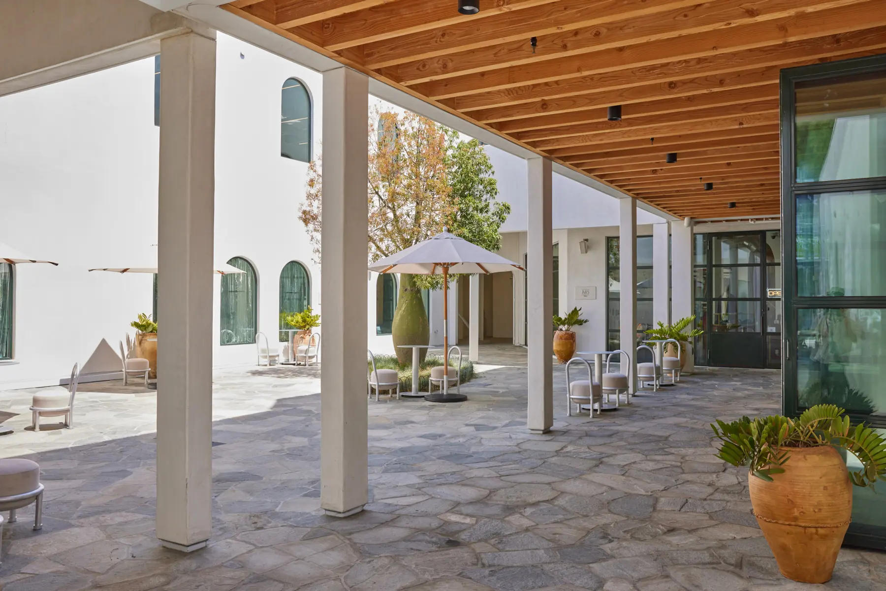 The arcade at Signal with a terracotta planter and stone paving