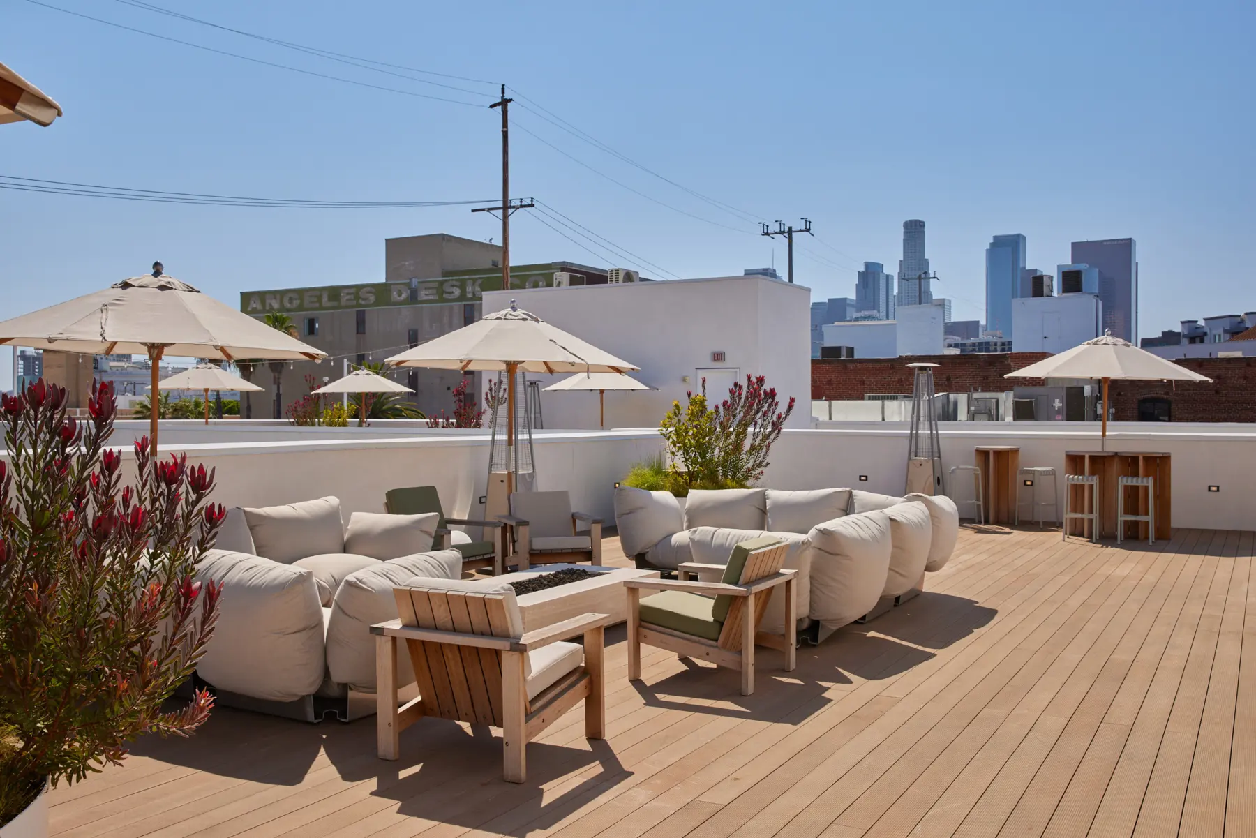 The roof deck at Signal with lounge seating and the downtown Los Angeles skyline