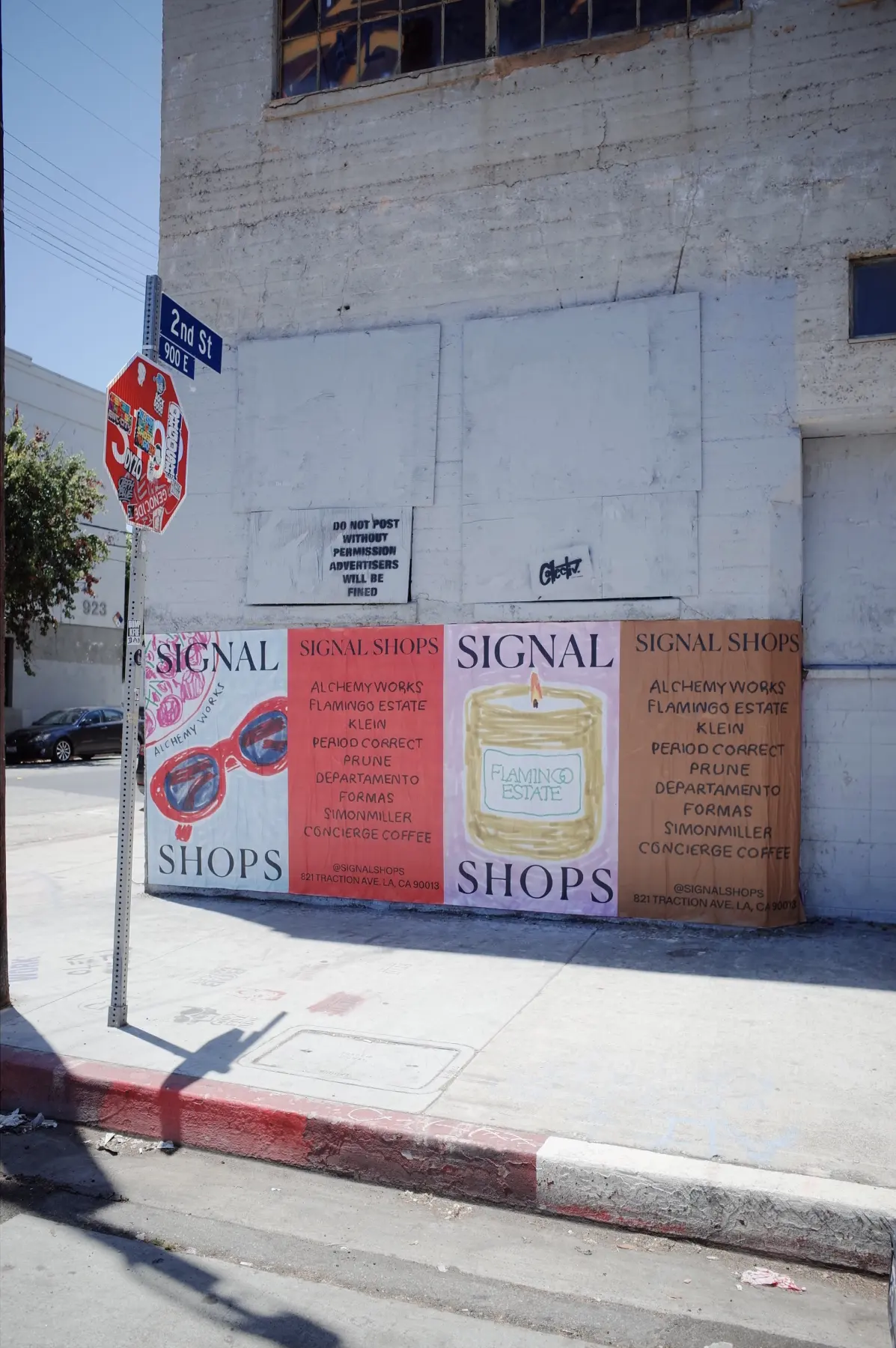 Signal wheatpaste posters on a street corner in the Arts District